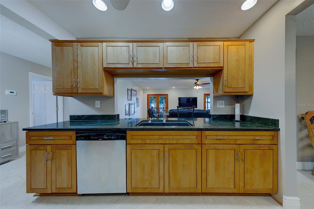 9628 122nd Way Seminole, FL 33772 - Photo 9 of 53 a kitchen with granite countertop wood cabinets and a sink