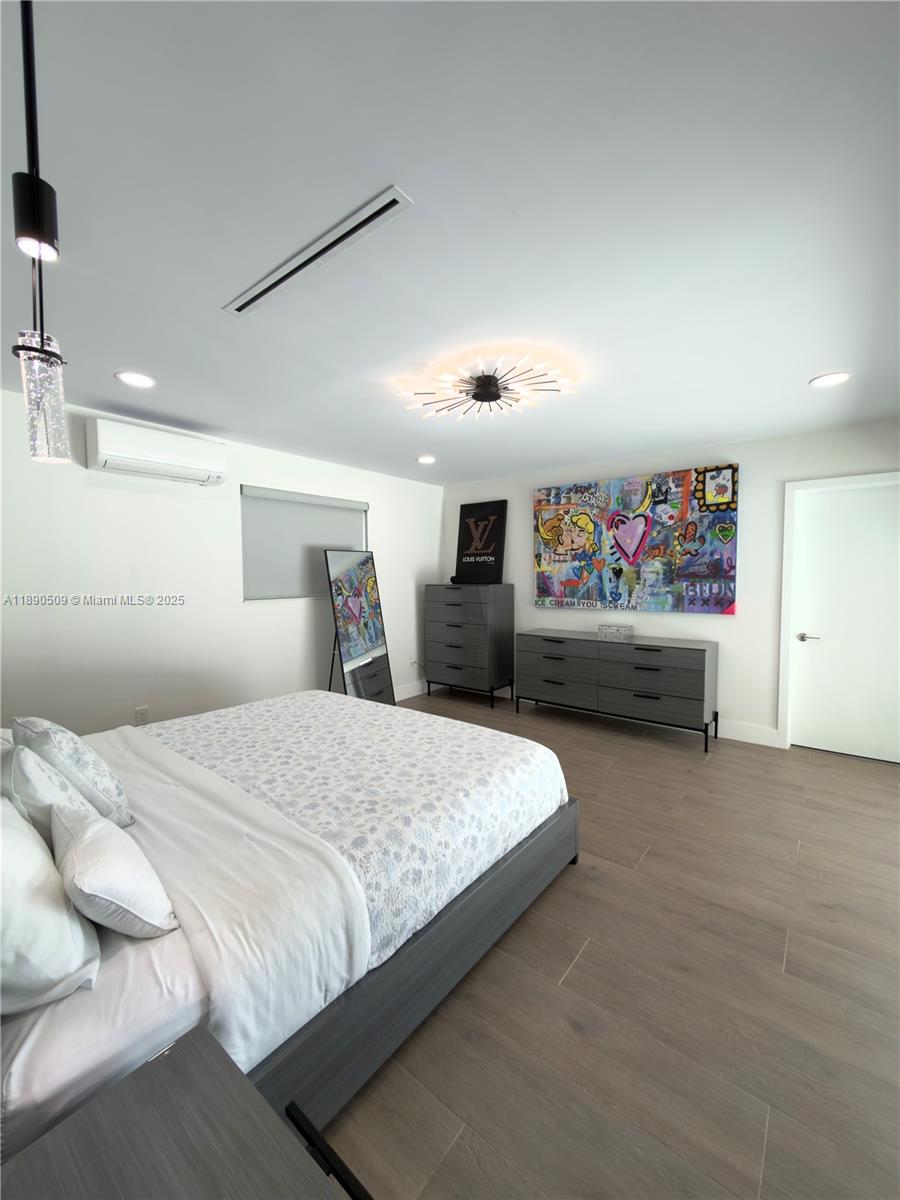 2350 Northeast 194th Street Miami, FL 33180 - Photo 12 of 24 a spacious bedroom with a bed and dresser