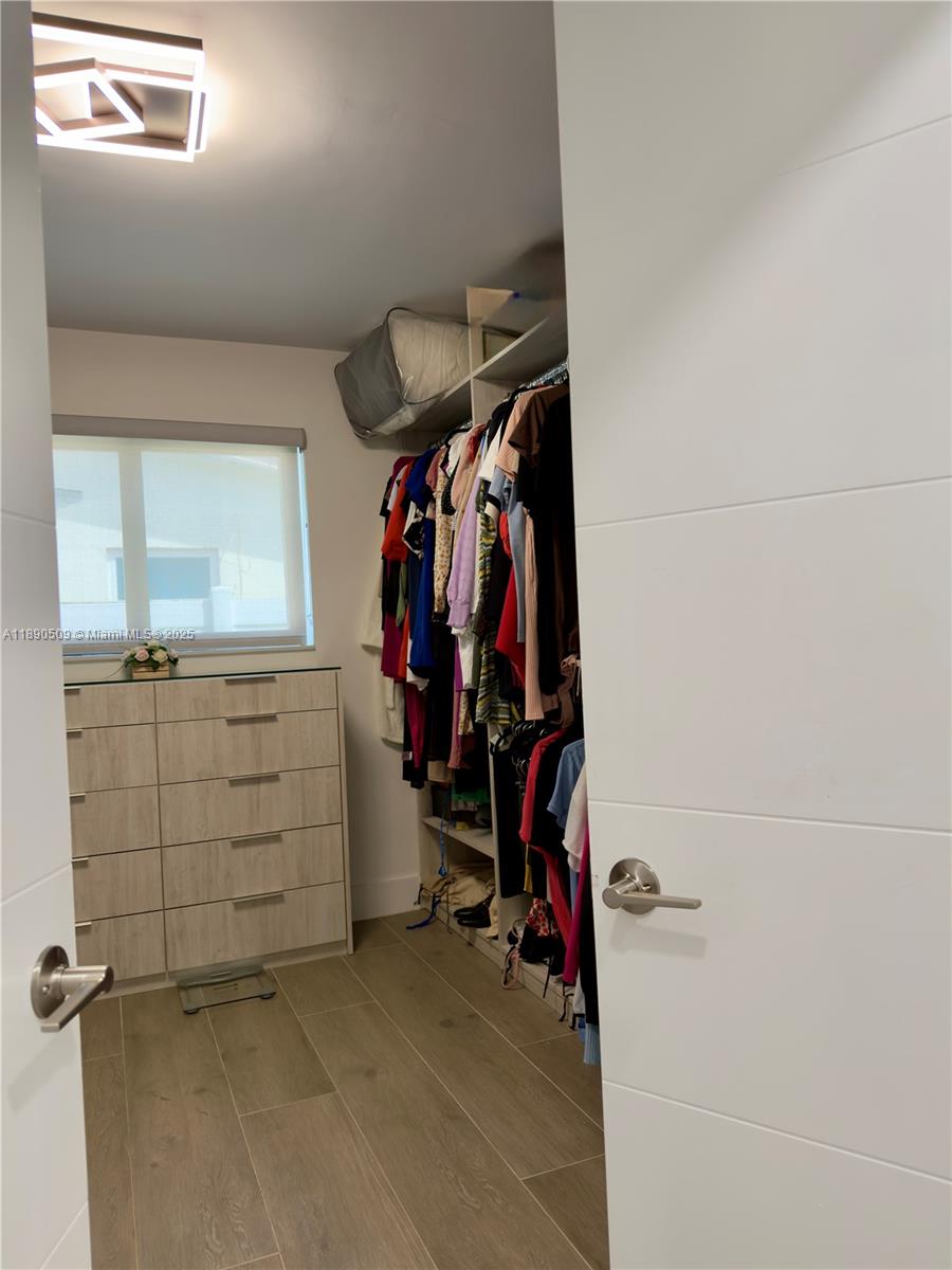 2350 Northeast 194th Street Miami, FL 33180 - Photo 14 of 24 a view of walk in closet with clothes
