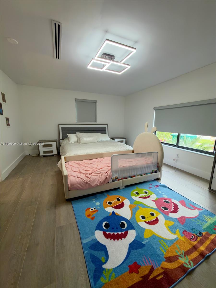 2350 Northeast 194th Street Miami, FL 33180 - Photo 16 of 24 a bedroom with a bed that has a lot of graffiti on it