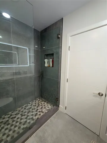 a bathroom with a shower and a sink