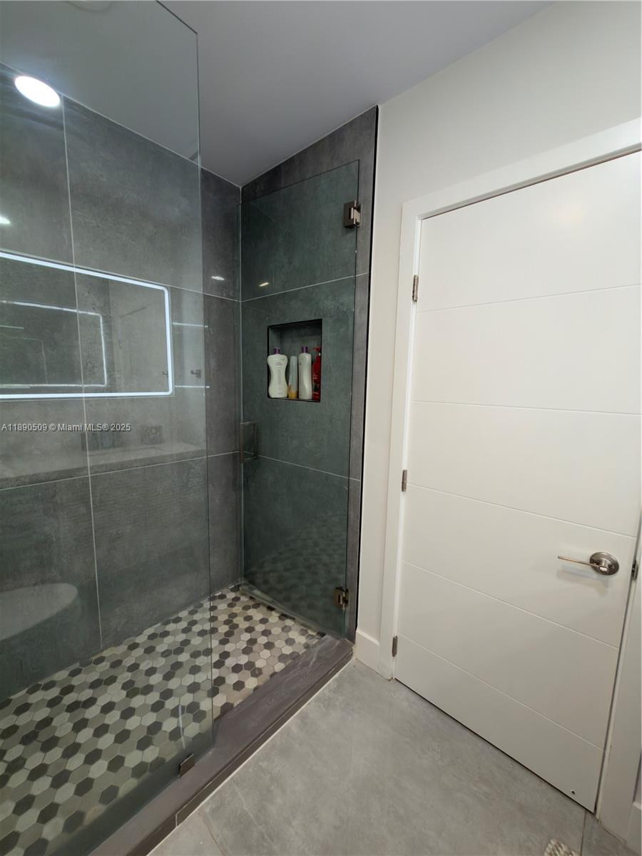 2350 Northeast 194th Street Miami, FL 33180 - Photo 17 of 24 a bathroom with a shower and a sink