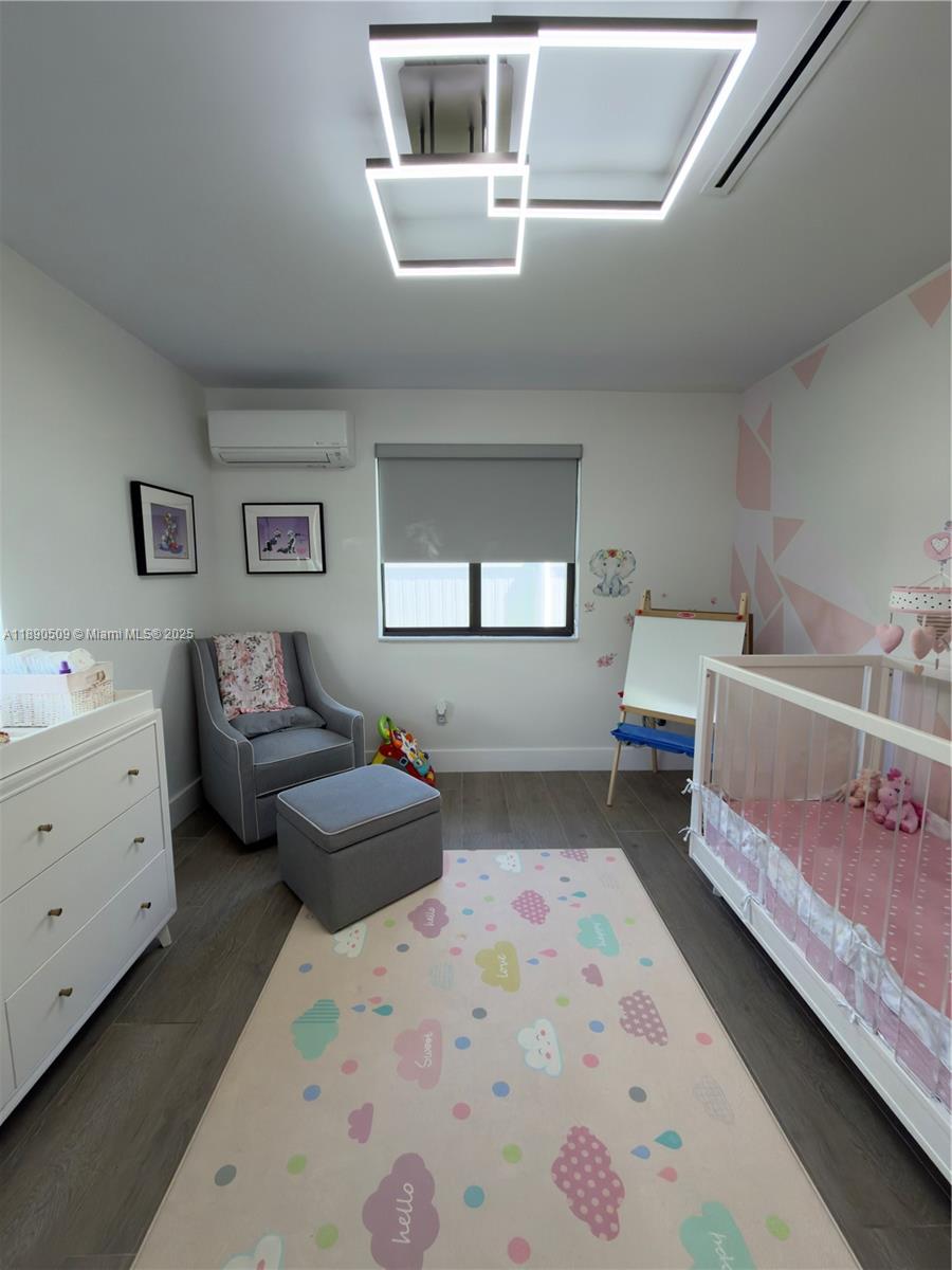 2350 Northeast 194th Street Miami, FL 33180 - Photo 19 of 24 a bedroom with a bed and a dresser