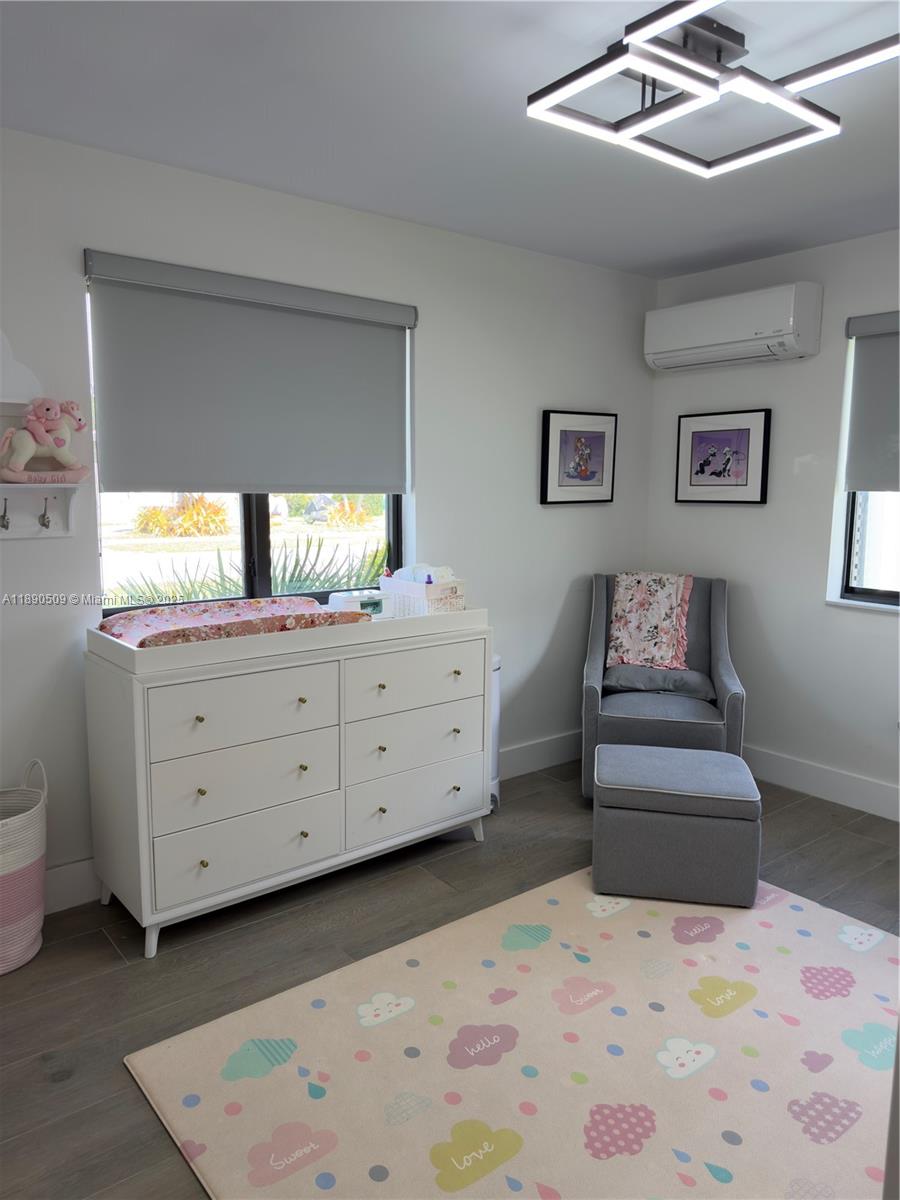 2350 Northeast 194th Street Miami, FL 33180 - Photo 20 of 24 a living room with furniture and a dresser