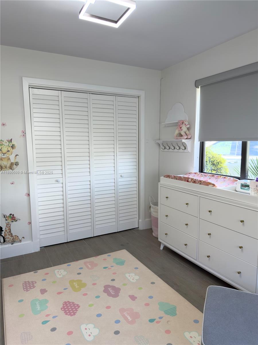 2350 Northeast 194th Street Miami, FL 33180 - Photo 21 of 24 a view of a bedroom with window and cabinet