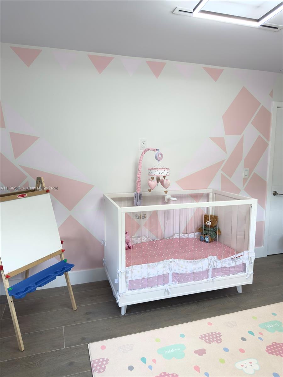 2350 Northeast 194th Street Miami, FL 33180 - Photo 22 of 24 a bedroom with a bed and a lamp on the dresser