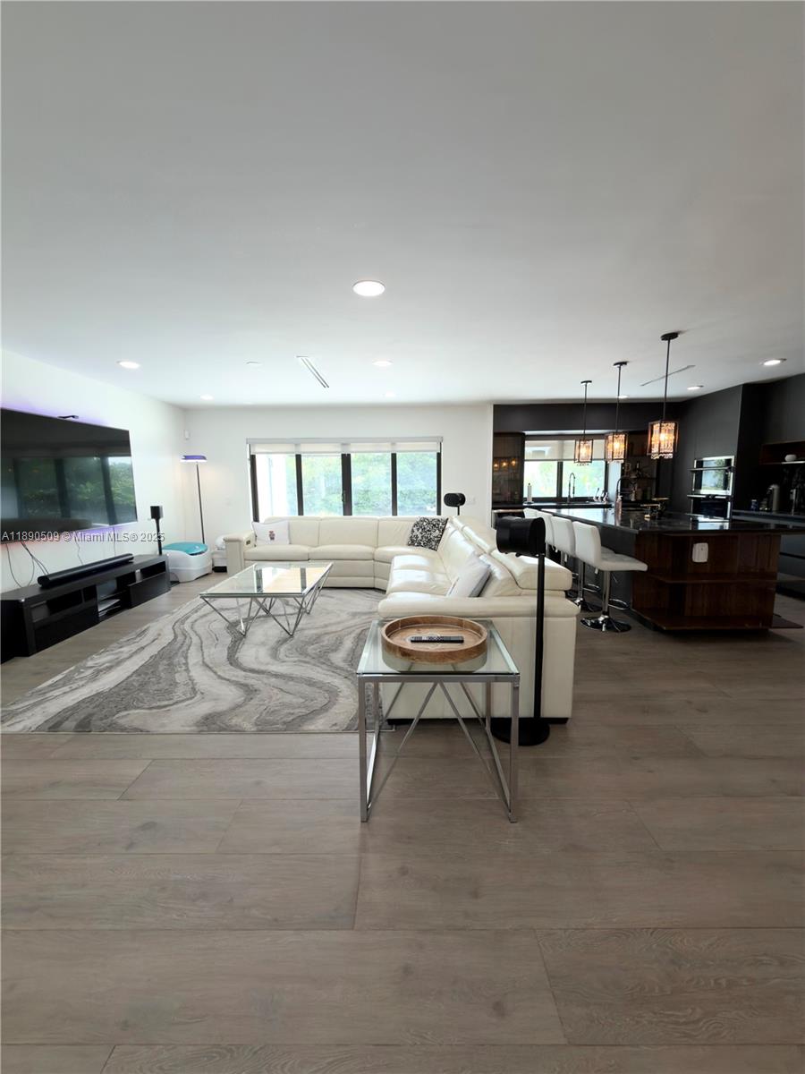 2350 Northeast 194th Street Miami, FL 33180 - Photo 3 of 24 a living room with furniture and a flat screen tv