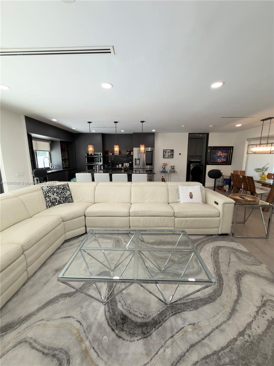 2350 Northeast 194th Street Miami, FL 33180 - Photo 5 of 24 a view of a living room kitchen and a chandelier