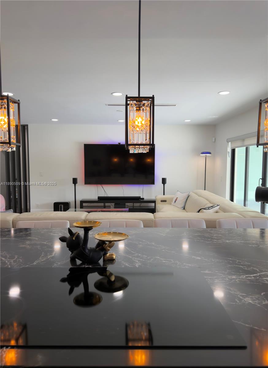 2350 Northeast 194th Street Miami, FL 33180 - Photo 7 of 24 a living room with furniture and a flat screen tv