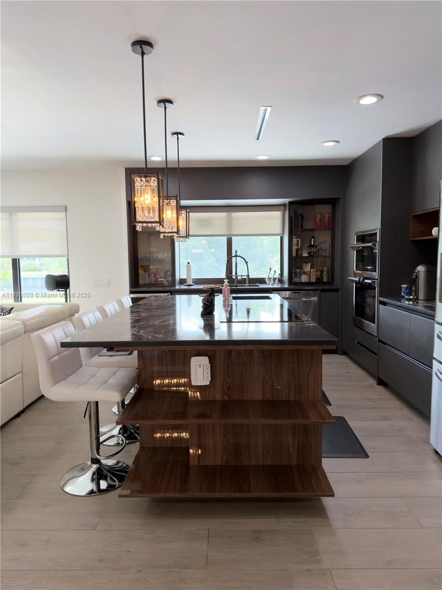 2350 Northeast 194th Street Miami, FL 33180 - Photo 8 of 24 a living room with furniture a window and kitchen view