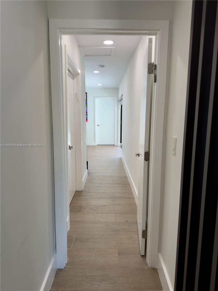 2350 Northeast 194th Street Miami, FL 33180 - Photo 10 of 24 a view of a hallway with wooden shelves
