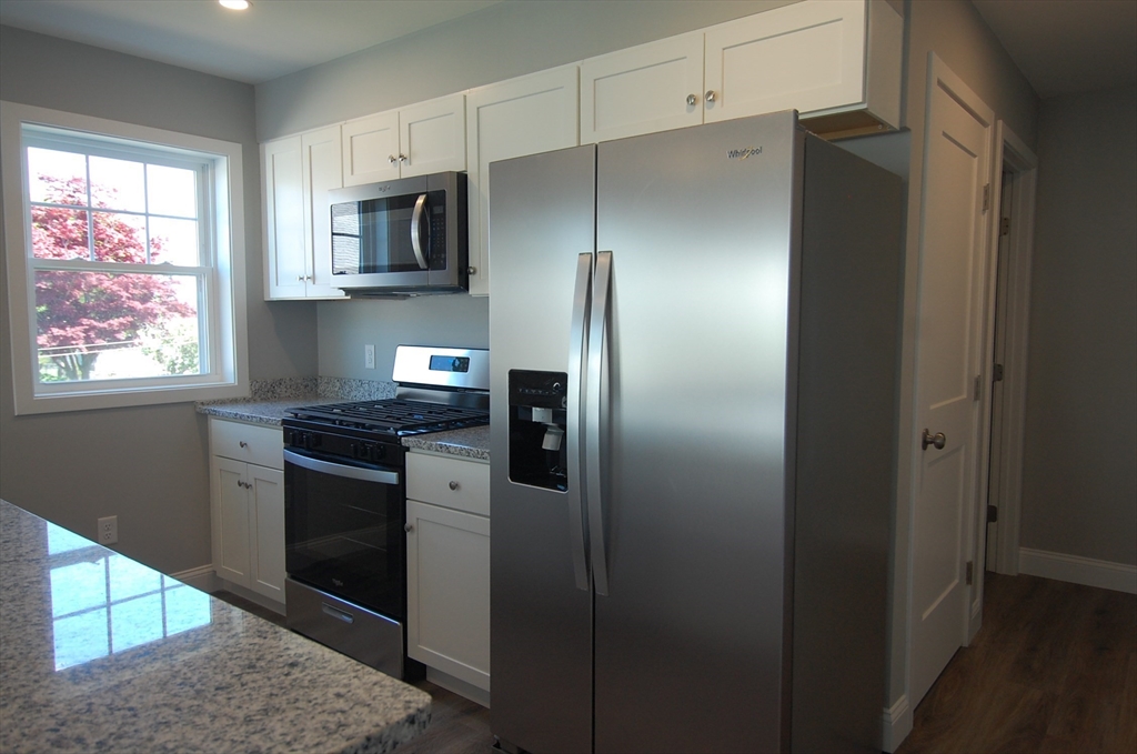 9 Bolton Road, Unit N Dartmouth, MA 02748 - Photo 4 of 19 a kitchen with stainless steel appliances granite countertop a refrigerator and a stove top oven