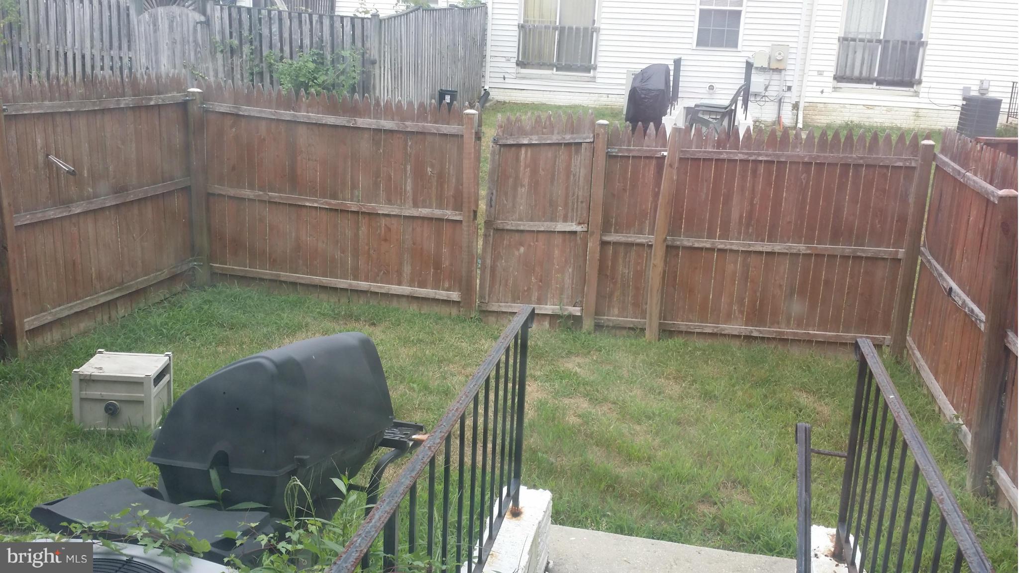 8659 Ritchboro Road District Heights, MD 20747 - Photo 13 of 13 a backyard of a house with a garden and plants