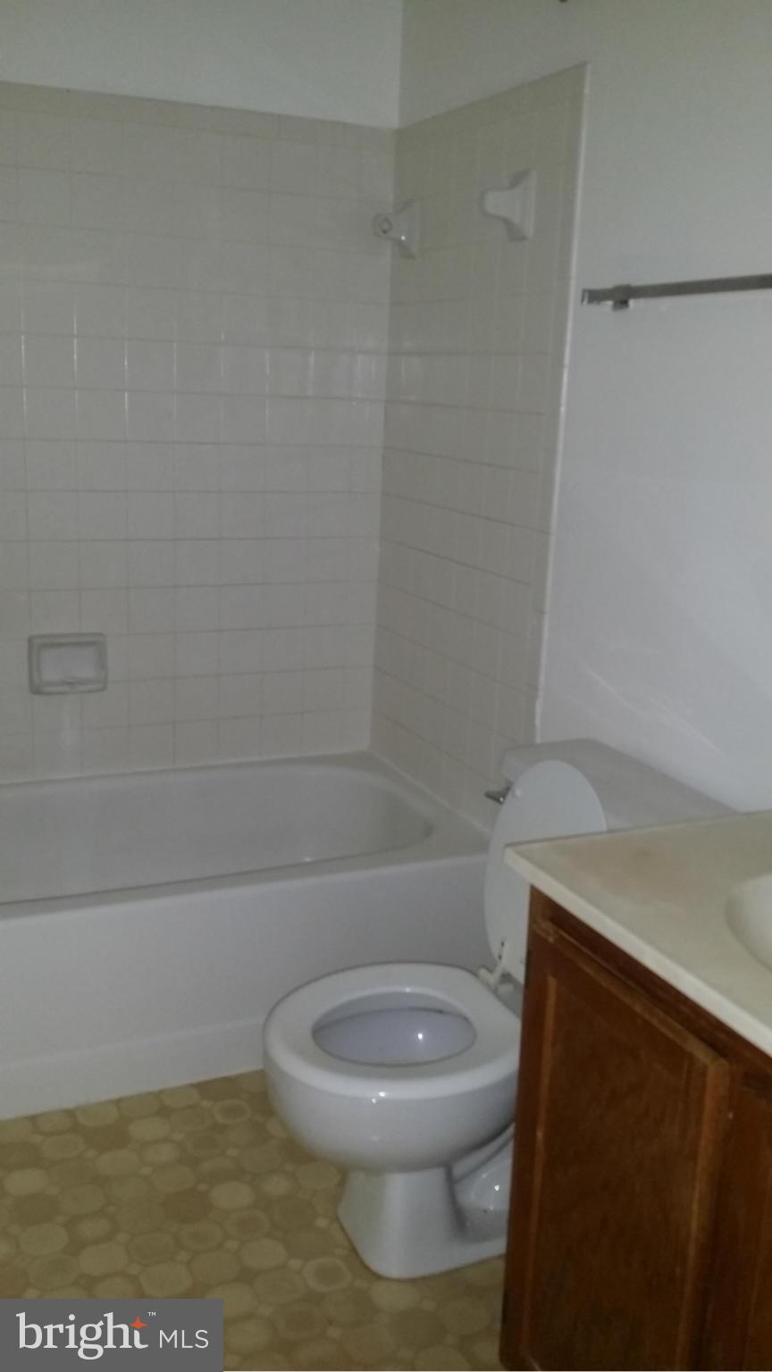 8659 Ritchboro Road District Heights, MD 20747 - Photo 10 of 13 a white toilet sitting next to a shower