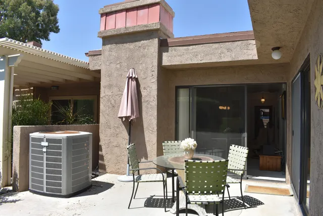 a view of a patio with table and chairs