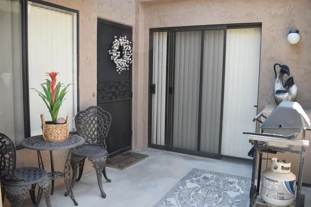 a view of a hallway with furniture and a potted plant