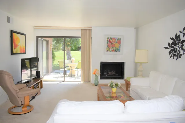 a living room with furniture a window and a fireplace