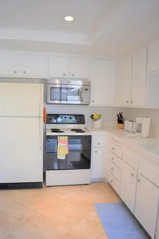 a kitchen with a stove and a refrigerator