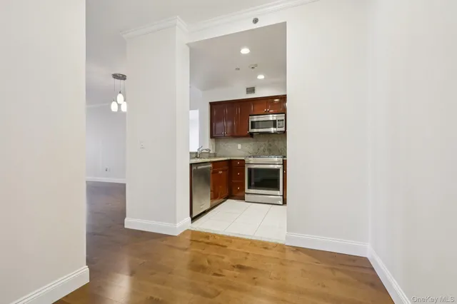 a kitchen with a sink and stainless steel appliances