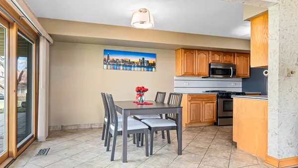 a dining area with a table and chairs in it