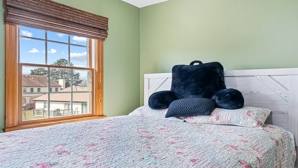 a bedroom with a large bed and a large window