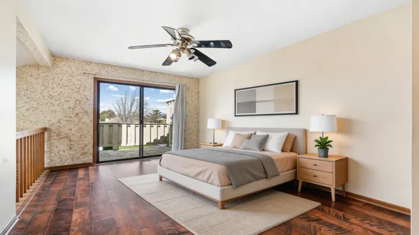 a bedroom with a large bed and a chandelier