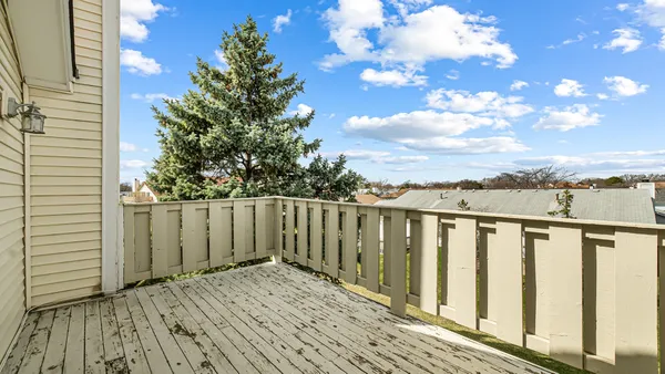 a view of wooden balcony with wooden fence