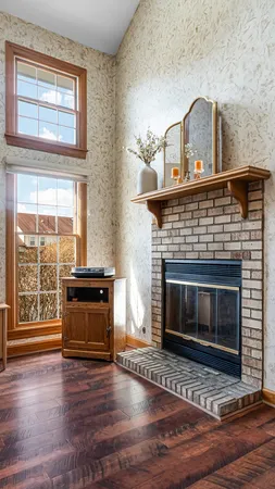 a living room with a fireplace and wooden floor