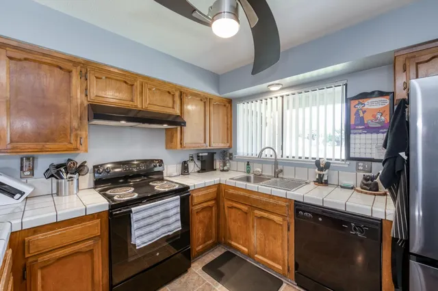 a kitchen with stainless steel appliances a stove sink microwave and cabinets