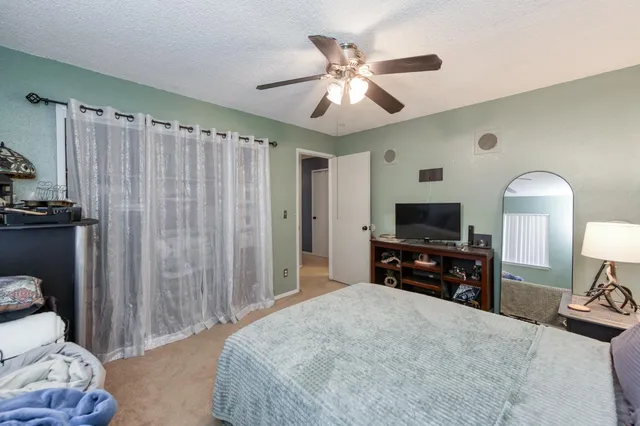 a bedroom with furniture and a flat screen tv