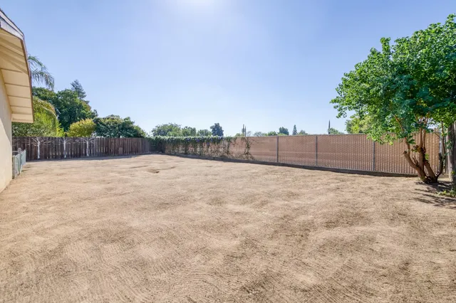 a view of a dinning table and chairs in patio of the house