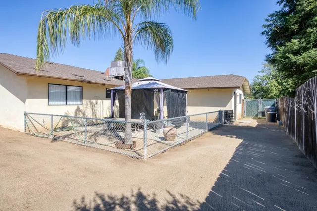 a view of a dinning table and chairs in patio of the house