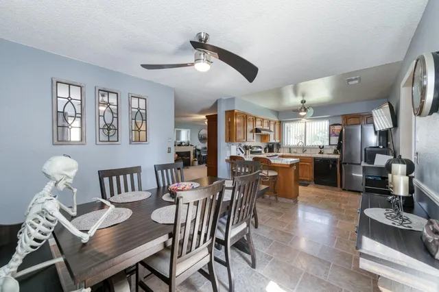 a view of a dining room with furniture and a large window