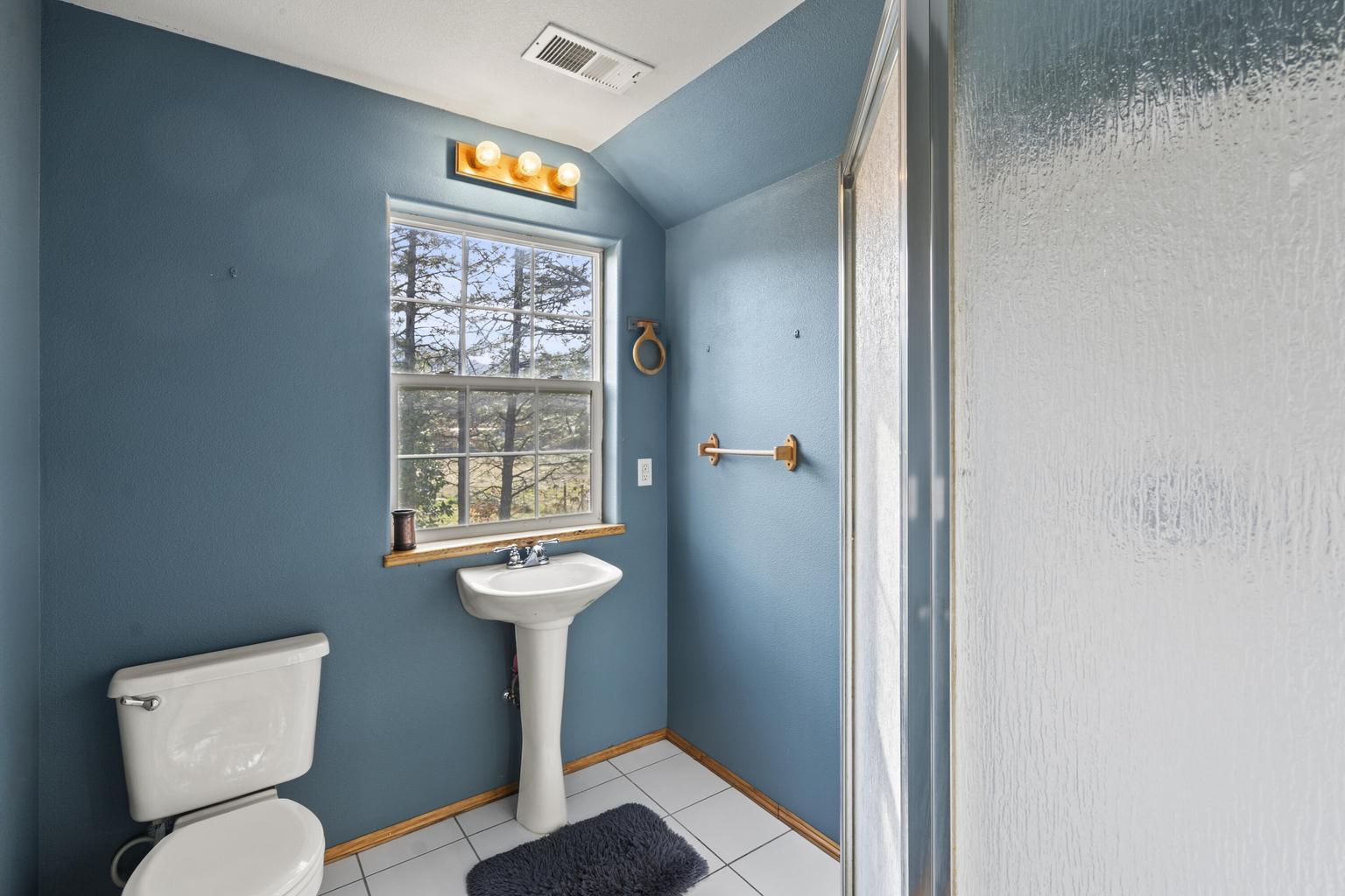 1190 Cedar Flat Road Williams, OR 97544 - Photo 15 of 45 a bathroom with a toilet sink and mirror