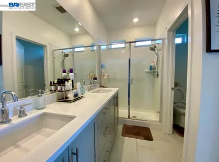 a bathroom with a sink double vanity and shower
