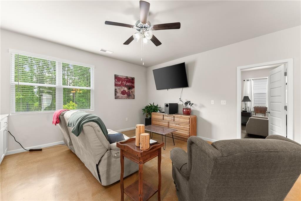 63 Conroe Court Hoschton, GA 30548 - Photo 11 of 44 a living room with furniture and a large window