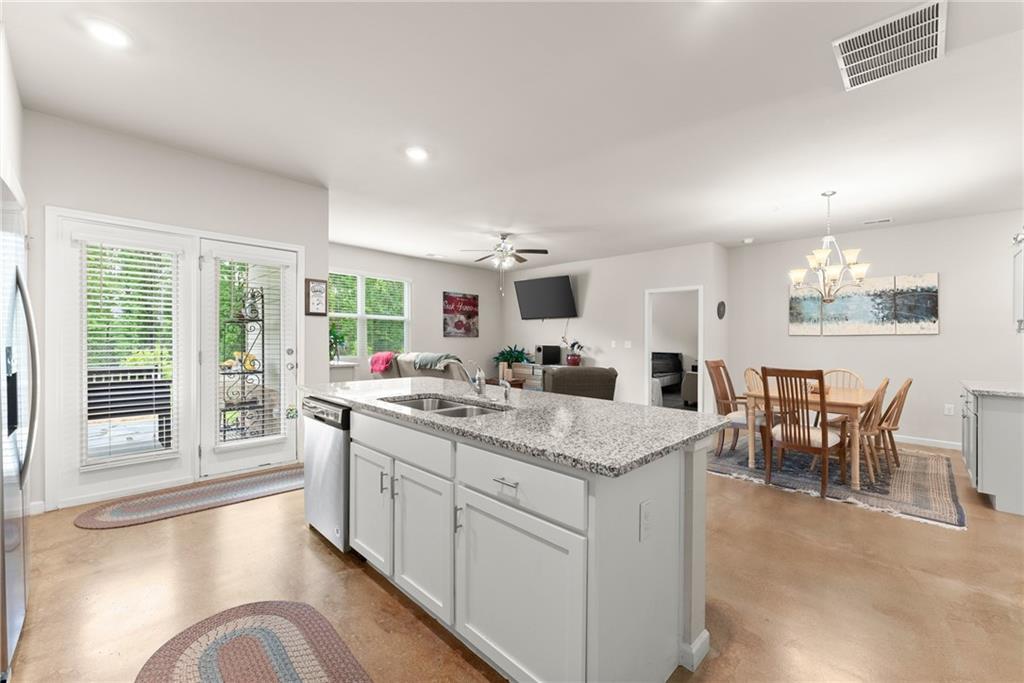 63 Conroe Court Hoschton, GA 30548 - Photo 16 of 44 a view of a kitchen counter space with furniture and living room