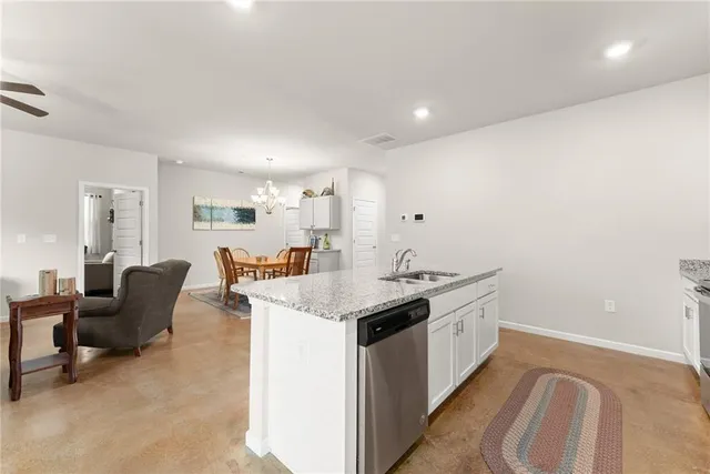 a kitchen with a sink and living room