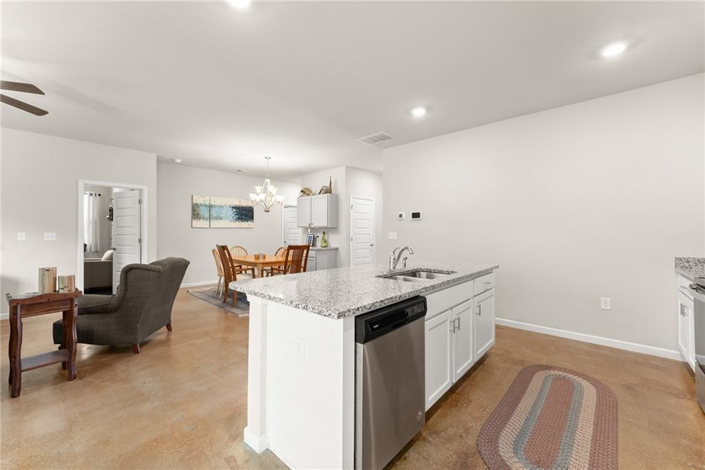 63 Conroe Court Hoschton, GA 30548 - Photo 17 of 44 a kitchen with a sink and living room