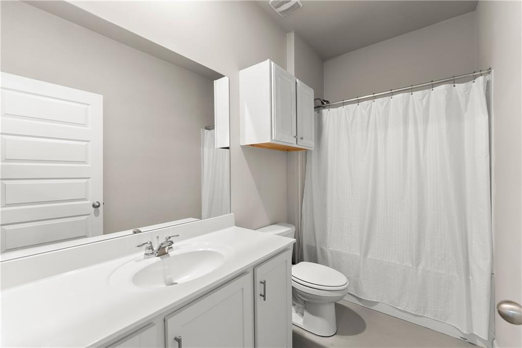 63 Conroe Court Hoschton, GA 30548 - Photo 20 of 44 a bathroom with a sink a toilet and shower