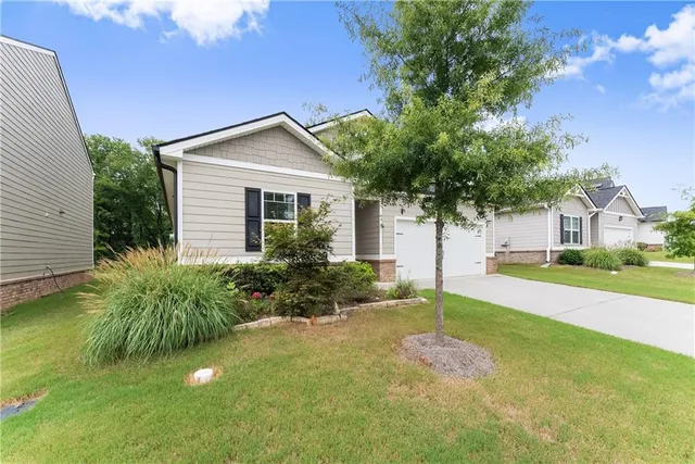 a house that has a tree in front of it
