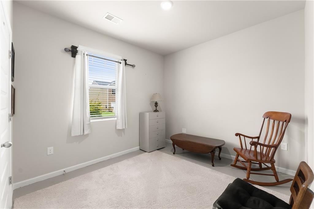 63 Conroe Court Hoschton, GA 30548 - Photo 21 of 44 a living room with furniture and a window
