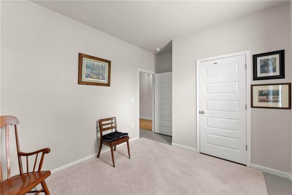 63 Conroe Court Hoschton, GA 30548 - Photo 22 of 44 a living room with furniture and a chair