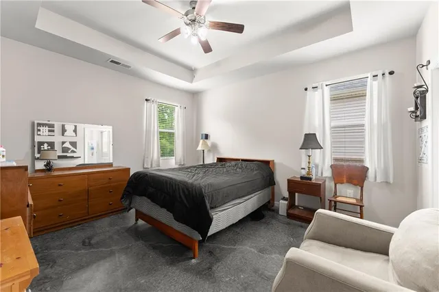 a bedroom with a bed and a couch