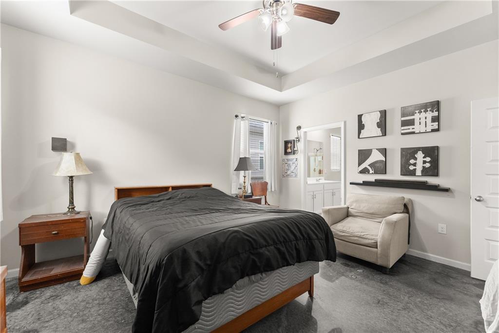 63 Conroe Court Hoschton, GA 30548 - Photo 24 of 44 a bedroom with a bed and a chandelier