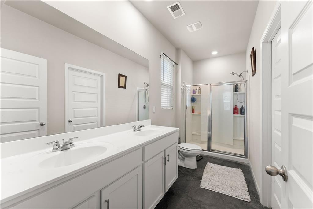 63 Conroe Court Hoschton, GA 30548 - Photo 26 of 44 a spacious bathroom with a double vanity sink mirror double and shower