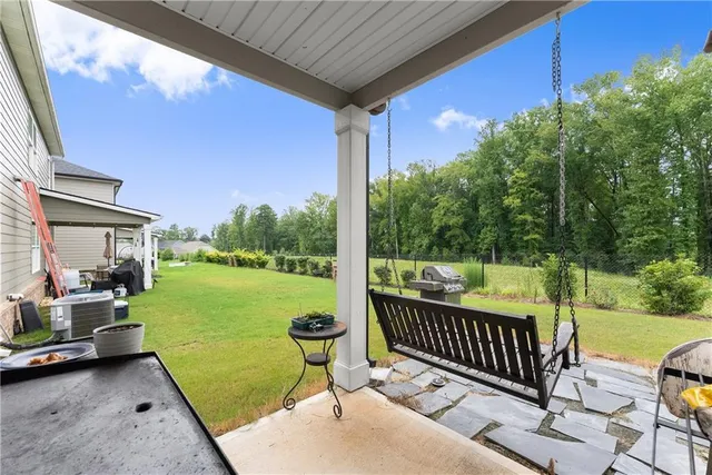 a view of a patio with a table chairs and a backyard