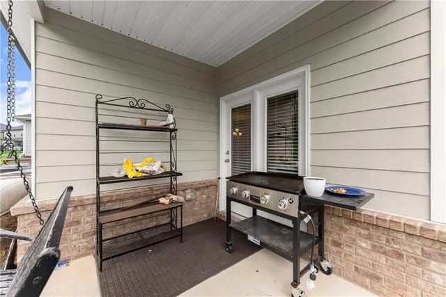 a backyard of a house with barbeque oven table and chairs