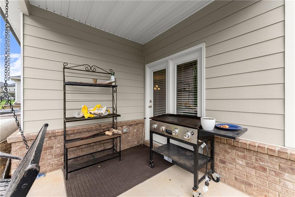 63 Conroe Court Hoschton, GA 30548 - Photo 29 of 44 a backyard of a house with barbeque oven table and chairs
