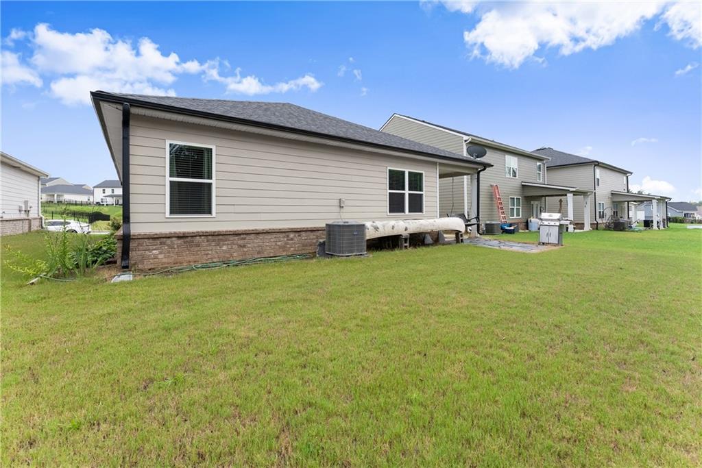 63 Conroe Court Hoschton, GA 30548 - Photo 33 of 44 a backyard of a house with table and chairs
